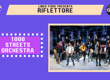 Il trombettista Martin Dequal, cofondatore con Denis Zupin di "The 1000 Streets Orchestra", è l'ospite della puntata di venerdì 22 aprile di "Riflettore", la trasmissione che mette in luce la musica che nasce in Friuli-Venezia Giulia. La formazione, che si è messa in luce negli ultimi anni grazie alla capacità di spaziare dal repertorio classico per big band al jazz moderno, strizzando al contempo l’occhio all’elettroswing, ha recentemente pubblicato il singolo “Hit the Road Jack” , un omaggio a Ray Charles e a tutta la musica swing e soul. The 1000 Streets’ Orchestra ha calcato numerosissimi palchi a partire dai più importanti teatri triestini (Rossetti, Bobbio, Miela) fino all’ultima tournée in Francia e Spagna. Il sound della formazione si è concretizzato un anno fa con l'uscita di “Electro Way”, un album che contiene sia brani originali, tra i quali il coinvolgente "Freedoom", sia cover di hit internazionali. Quest’estate la 1000Streets si esibirà dal vivo con “Electro Way”, uno show completo e musicalmente ricchissimo, impreziosito ulteriormente dalle coreografie esplosive delle ballerine Giorgia Kero e Alice Cenzon. L’omonimo album ha raggiunto in pochi mesi un grande riscontro in Italia e all’estero con vette di oltre 200.000 ascoltatori su Spotify. Fra gli appuntamenti live confermati, quello di venerdì 22 luglio nella giornata inaugurale del Festival di Majano, in provincia di Udine.